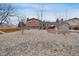 Spacious backyard with rock landscaping, wood deck, detached shed, and privacy fence at 1301 S Yampa Ct, Aurora, CO 80017