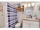 Bathroom featuring a shower with blue and white curtain and a granite vanity top at 1301 S Yampa Ct, Aurora, CO 80017