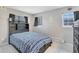 Bedroom with dark grey furniture, wood floors, and three windows at 1301 S Yampa Ct, Aurora, CO 80017