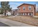 Charming exterior showcasing a well-maintained front yard and classic brick accents on a split-level home at 1301 S Yampa Ct, Aurora, CO 80017