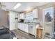 Bright kitchen with stainless appliances, white cabinets, and a view to the deck at 1301 S Yampa Ct, Aurora, CO 80017