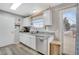 Well-lit kitchen with stainless appliances, white cabinetry, and deck access at 1301 S Yampa Ct, Aurora, CO 80017