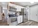 Bright kitchen with stainless steel appliances and white cabinets, ample countertop space at 1301 S Yampa Ct, Aurora, CO 80017