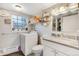 Laundry room features laundry machine, granite sink, and custom window at 1301 S Yampa Ct, Aurora, CO 80017