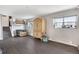 Spacious living room with wood-look tile and natural light from the windows at 1301 S Yampa Ct, Aurora, CO 80017