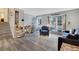 Inviting living room featuring wood floors, neutral paint, large windows, and an abundance of natural light at 1301 S Yampa Ct, Aurora, CO 80017