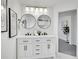 Stylish bathroom with double vanity, large mirrors, and modern fixtures at 7115 Geneva Ct, Lakewood, CO 80214