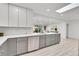 Updated kitchen featuring gray cabinets, white countertops, and stainless steel appliances at 7115 Geneva Ct, Lakewood, CO 80214