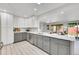 Modern kitchen with gray cabinets, white countertops, and stainless steel appliances at 7115 Geneva Ct, Lakewood, CO 80214