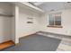Unfinished basement room with tile accents and natural light from window at 7681 S Jellison St, Littleton, CO 80127