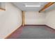 Finished basement with carpet, exposed beam, and neutral wall color at 7681 S Jellison St, Littleton, CO 80127