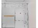 Bathroom showing tub with glass sliding door, white tile with red accents at 7681 S Jellison St, Littleton, CO 80127