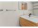 Bathroom showing a modern vanity with a sink, faucet, a bright mirror and a towel bar at 7681 S Jellison St, Littleton, CO 80127