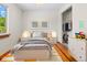 Bright bedroom with a closet, wood floors, neutral walls, rug and natural light coming in from the window at 7681 S Jellison St, Littleton, CO 80127