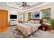 Inviting bedroom with a ceiling fan and natural light from the windows, showcasing neutral tones at 7681 S Jellison St, Littleton, CO 80127