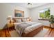 Bedroom features hardwood floors, neutral walls, soft rug, and natural light coming in from a window at 7681 S Jellison St, Littleton, CO 80127