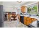 Bright kitchen with stainless steel appliances, light countertops, and a view of a dining area at 7681 S Jellison St, Littleton, CO 80127