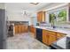 Spacious kitchen with tile flooring, wood cabinets, white countertops, and stainless steel appliances at 7681 S Jellison St, Littleton, CO 80127