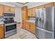 Close up on kitchen with stainless steel appliances, including a modern refrigerator and range at 7681 S Jellison St, Littleton, CO 80127