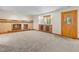 Living room highlighting a fireplace, built-in cabinets, tiled floors, neutral walls, and natural light at 7681 S Jellison St, Littleton, CO 80127