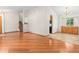 Open-concept living area with gleaming hardwood floors and neutral tones at 7681 S Jellison St, Littleton, CO 80127