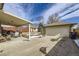 Covered patio with seating area, adjacent to a two-car garage and basketball hoop at 4840 Depew St, Denver, CO 80212