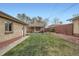 Green backyard with a covered patio and brick detached garage offers a relaxed outdoor space at 4840 Depew St, Denver, CO 80212