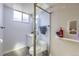 Cozy bathroom features a glass enclosed shower, a vanity, and white toilet at 4840 Depew St, Denver, CO 80212