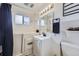 This well-lit bathroom features a walk-in tub, modern fixtures, and ample cabinet space at 4840 Depew St, Denver, CO 80212