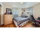 This bedroom features hardwood floors, curtains, and a light colored dresser at 4840 Depew St, Denver, CO 80212