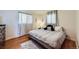 Comfortable bedroom with a large bed, soft lighting, and hardwood floors for a cozy retreat at 4840 Depew St, Denver, CO 80212
