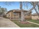 Charming brick home enhanced by mature tree, offering curb appeal and a welcoming atmosphere at 4840 Depew St, Denver, CO 80212