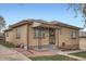Charming single-story brick home with an inviting entryway and well-maintained landscaping on a sunny day at 4840 Depew St, Denver, CO 80212