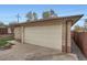 Spacious detached garage with a large door and brick facade at 4840 Depew St, Denver, CO 80212