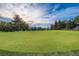 Scenic golf course with a green lawn and views of distant mountains at 4840 Depew St, Denver, CO 80212