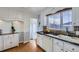 Functional kitchen with white cabinets, contrasting countertops, stainless steel sink and modern faucet at 4840 Depew St, Denver, CO 80212