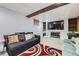 A beautifully finished basement living room featuring a fireplace and lots of seating at 4840 Depew St, Denver, CO 80212