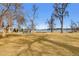 Picturesque park featuring a fun playground with swings, slides, and picnic tables near a serene lake at 4840 Depew St, Denver, CO 80212