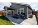 Backyard featuring a lawn, privacy fence, and a patio with a dining set and grill at 719 S Hoover Ave, Fort Lupton, CO 80621