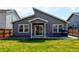 Backyard featuring a lawn, privacy fence, and a patio with a dining set and grill at 719 S Hoover Ave, Fort Lupton, CO 80621