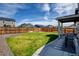 Backyard featuring a lawn, privacy fence, and a patio with a dining set and grill at 719 S Hoover Ave, Fort Lupton, CO 80621