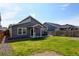 Backyard featuring a lawn, privacy fence, and a patio with a dining set and grill at 719 S Hoover Ave, Fort Lupton, CO 80621