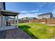 Backyard featuring a lawn, privacy fence, and a patio with a dining set and grill at 719 S Hoover Ave, Fort Lupton, CO 80621