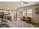 Inviting living room featuring wood flooring, modern furniture, and easy access to the backyard at 719 S Hoover Ave, Fort Lupton, CO 80621