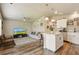 Open-concept living room with kitchen island and modern decor provides a cozy atmosphere at 719 S Hoover Ave, Fort Lupton, CO 80621