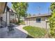 Private backyard featuring a patio area, landscaped yard, and detached garage at 1731 S Ogden St, Denver, CO 80210