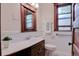 This bathroom features a beautiful vanity with a white countertop and a dark wood frame window with great natural light at 1731 S Ogden St, Denver, CO 80210