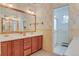 Charming bathroom with dual vanity, floral wallpaper, and a separate shower area at 1731 S Ogden St, Denver, CO 80210