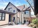 Charming home features a two-tone exterior with black trim and a well-maintained yard at 1731 S Ogden St, Denver, CO 80210