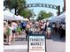 A vibrant farmers market bustling with vendors and shoppers under the South Pearl Street arch at 1731 S Ogden St, Denver, CO 80210